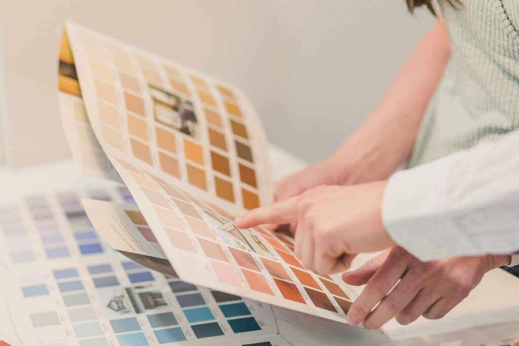 Two people discussing and choosing color palettes for interior design projects.